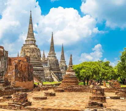Three bell-shaped chedis of Wat Phra Si Sanphet at Ayutthaya under a blue cloudy sky